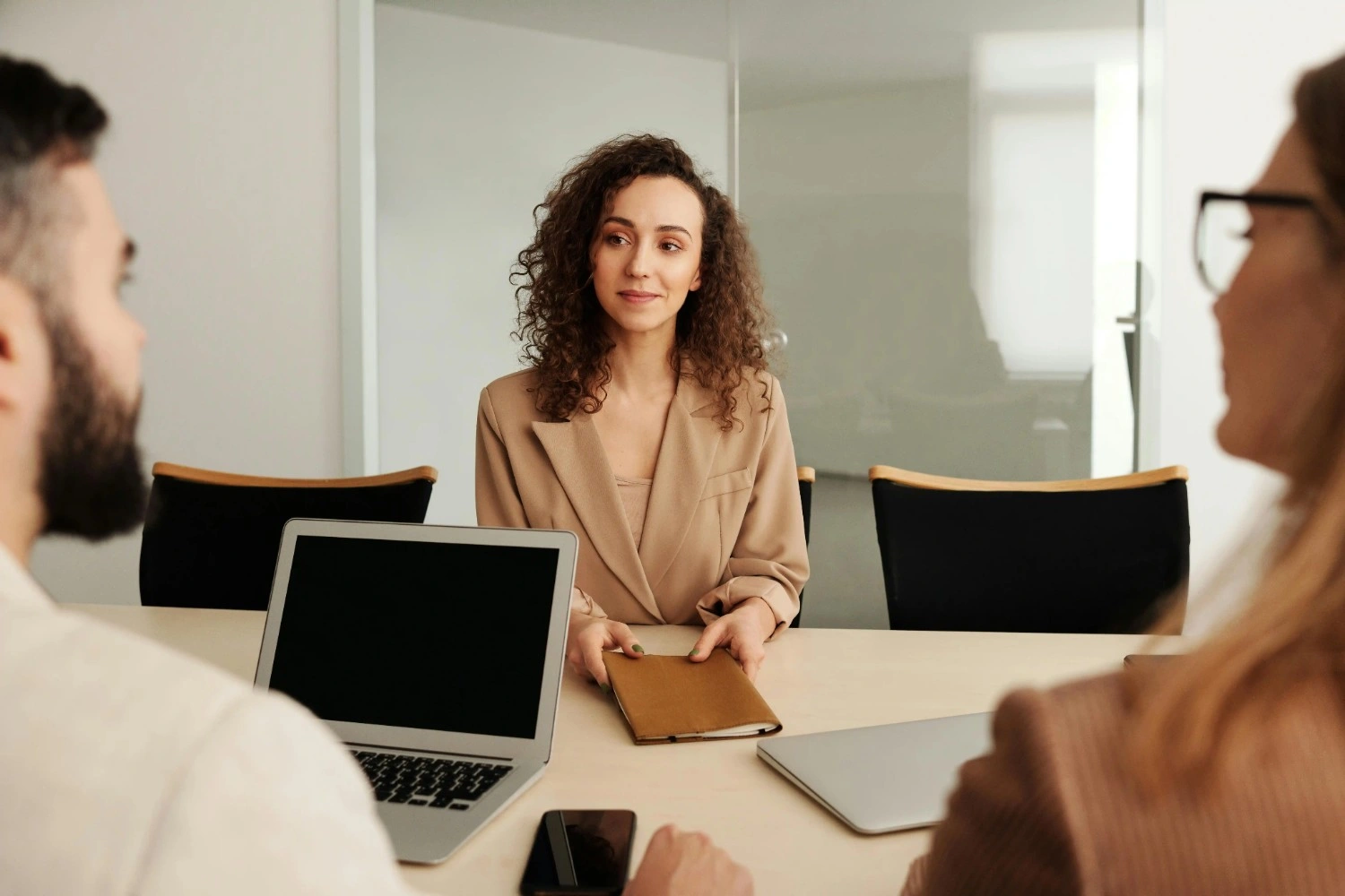 A Meera Consulting team member meeting a client across the table